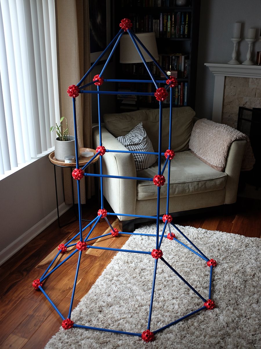 A rocket-shaped structure, about four feet tall and made of snap-together rods, standing in my living room.