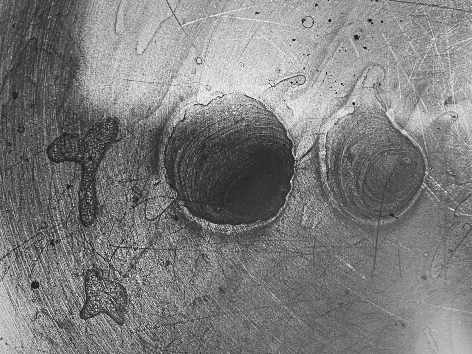 A high-contrast black and white image of pasta water residue at the bottom of a pot. It looks sort of hand-drawn.